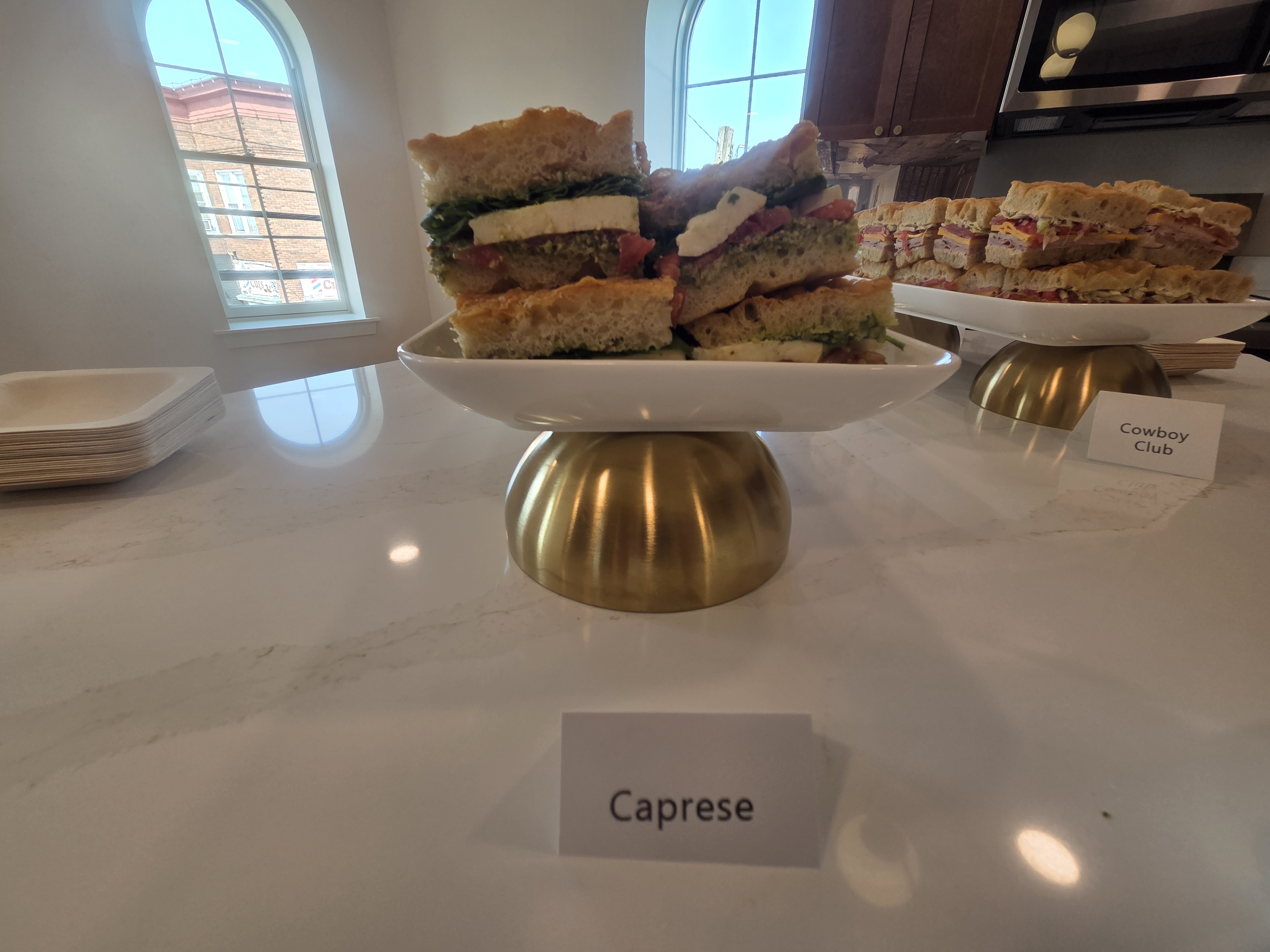 Caprese sandwiches, with Cowboy Club sandwiches behind them.