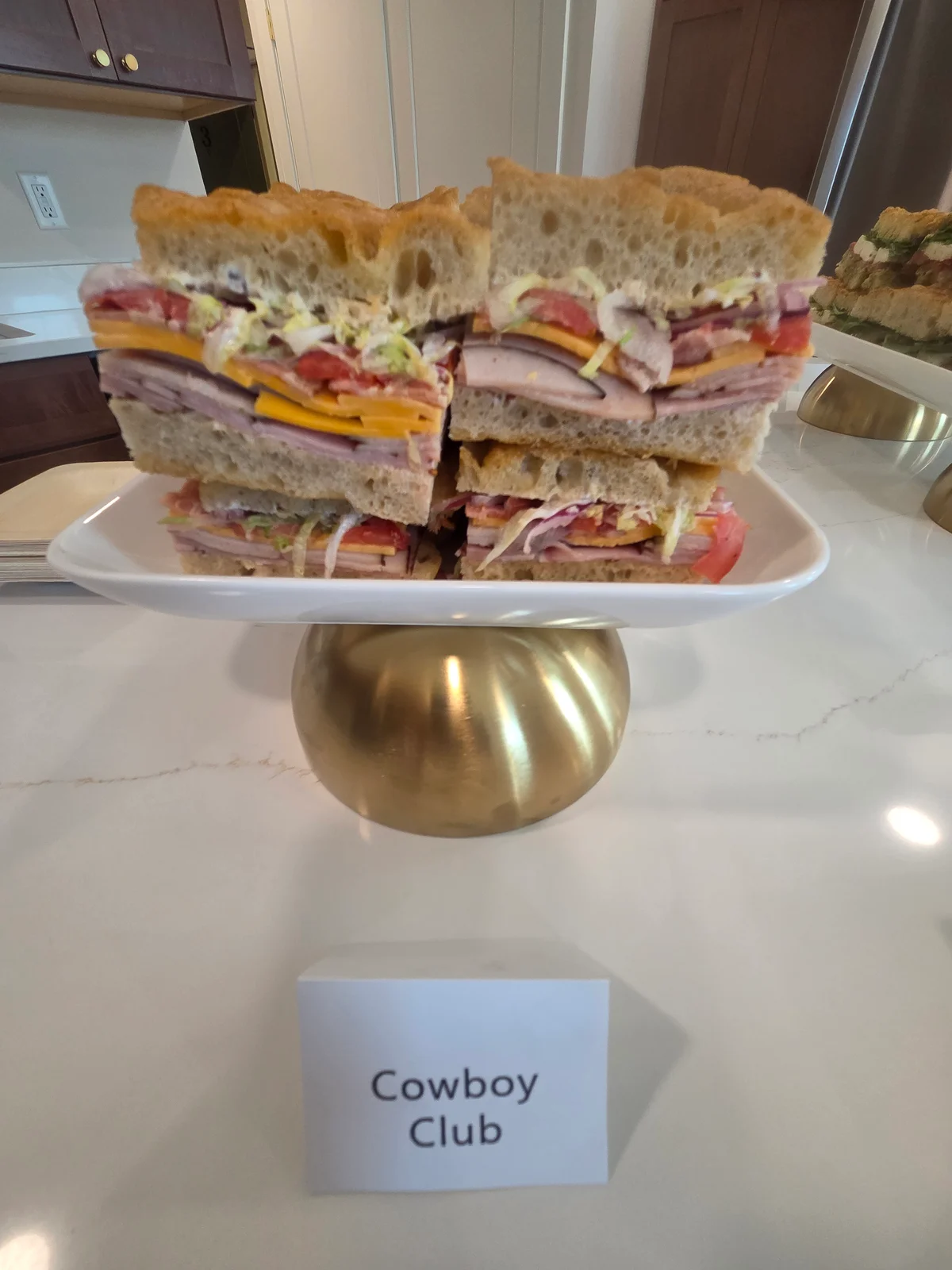 Cowboy Club sandwiches stacked on a serving stand.